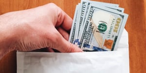 putting money in an envelope
