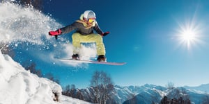 winter-jumping-a-hill-on-a-snowboard